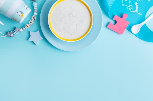 Baby plate with porridge on blue