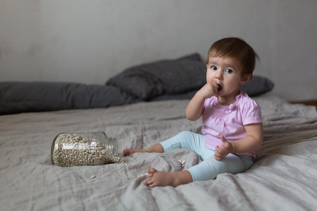 Baby playing on bed of beans early development natural toys lifestyle