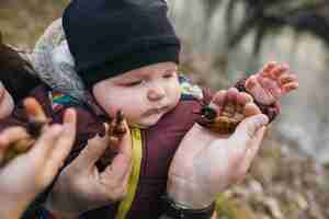 Free photo baby playing with toys and parents