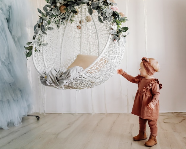 Free photo baby posing in swing