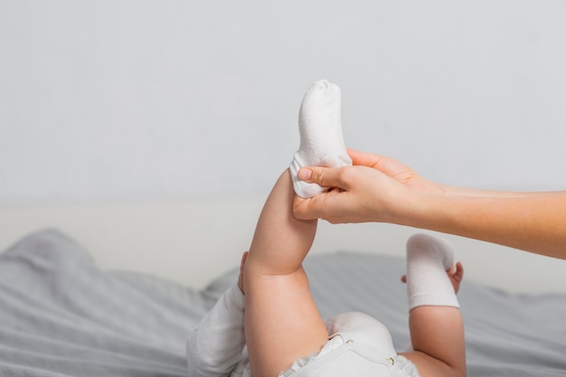 Free photo baby putting on socks