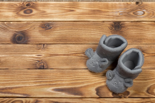 Baby's bootee on wooden background