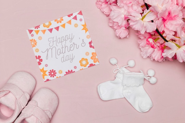Baby shoes with card and flowers for mothers day
