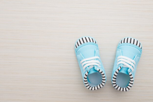 Baby shoes on wooden background