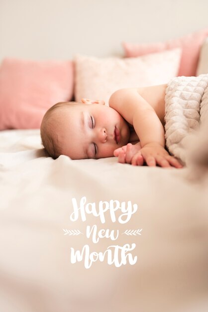 Baby sleeping with happy new month lettering