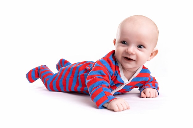 Baby in a striped bodysuit on a white isolated background with a smile on his face
