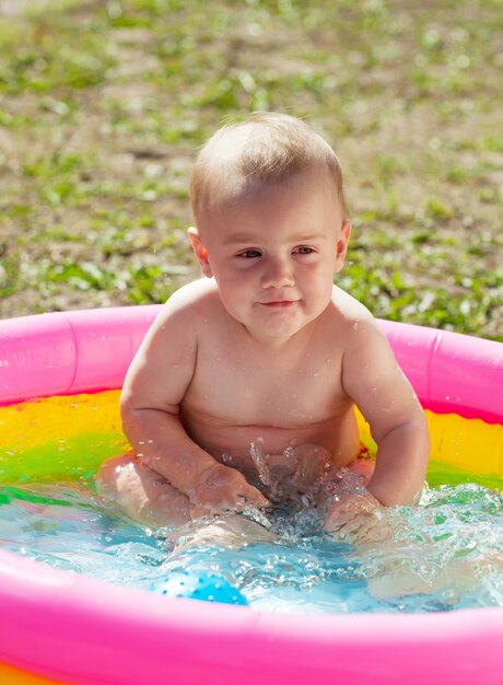 Baby swimming  in kid inflatable pool