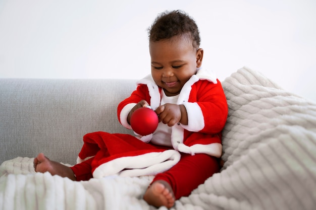 Free photo baby wearing santa outfit full shot