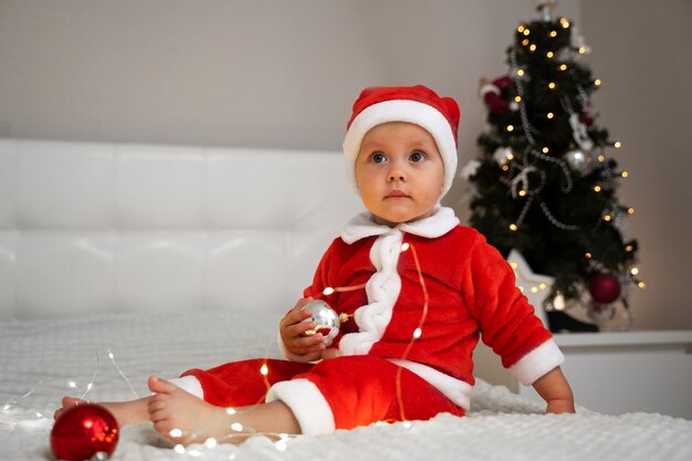 Baby wearing santa outfit full shot