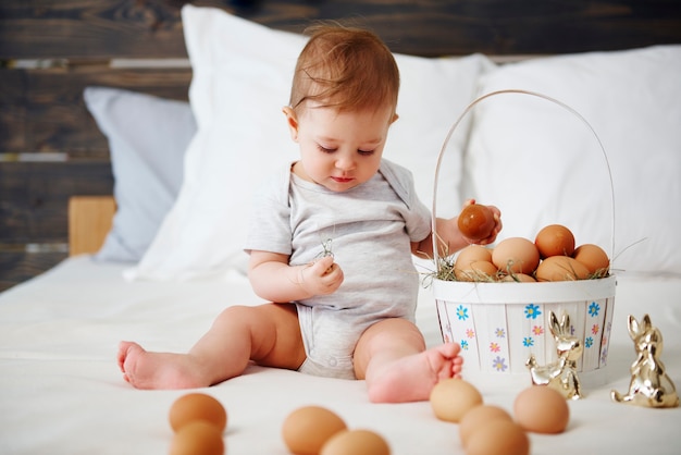 Baby with easter basket of eggs