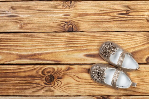 Babys bootee on wooden background