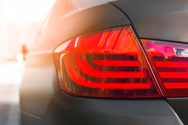 Free photo back of dark automobile with modern rear light