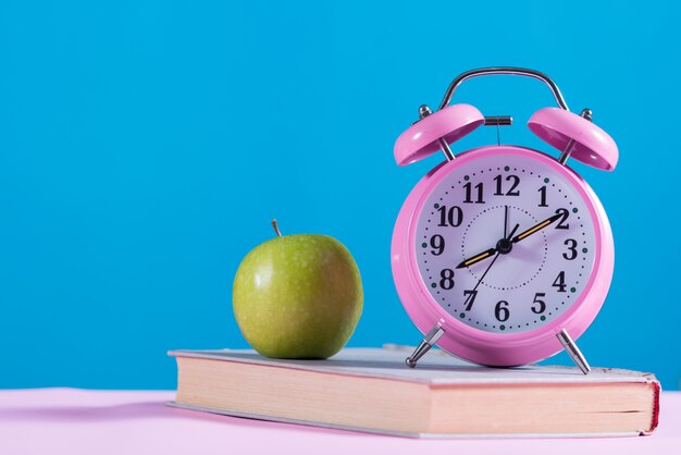 書籍、アップルと目覚まし時計で学校の背景に戻る