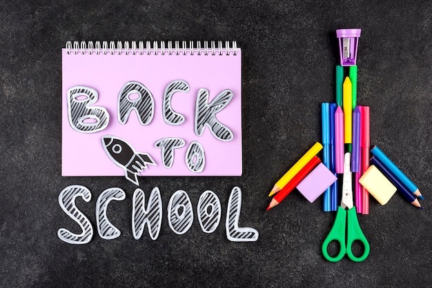 Back to school background with rocketship and notebook