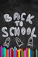 Free photo back to school background with school supplies on chalkboard