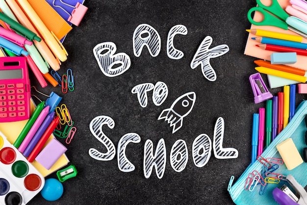 Back to school background with school supplies on chalkboard