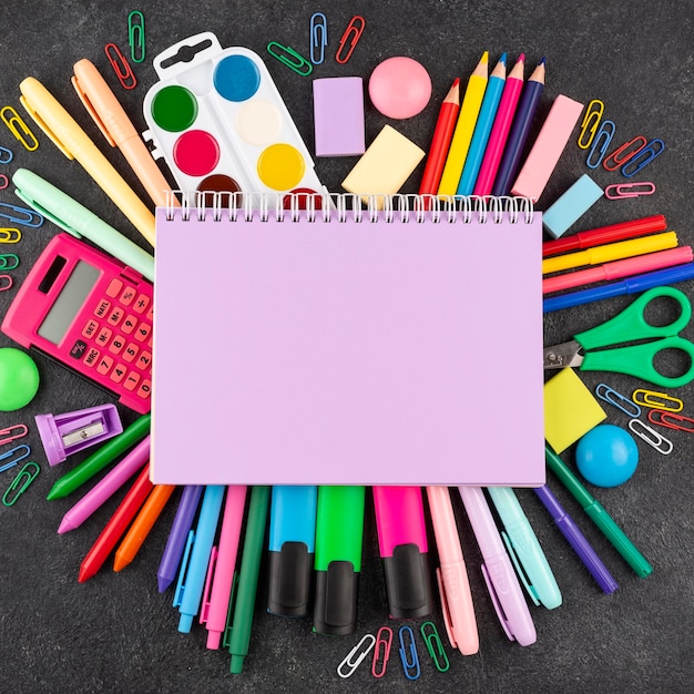 Back to school background with school supplies and copy space on notebook
