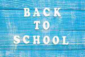 Free photo back to school banner with the inscription in wooden letters top view