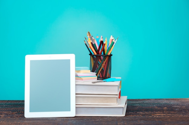 Back to School concept. Books, colored pencils and laptop