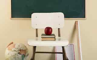 Free photo back to school concept with apple on chair
