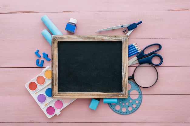 Back to school concept with slate and artistic objects