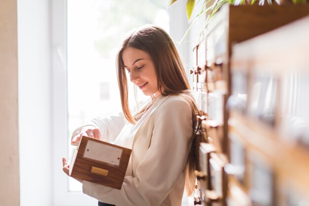 Back to school concept with woman studying in library