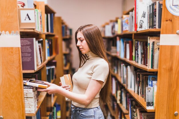 Back to school concept with woman studying in library