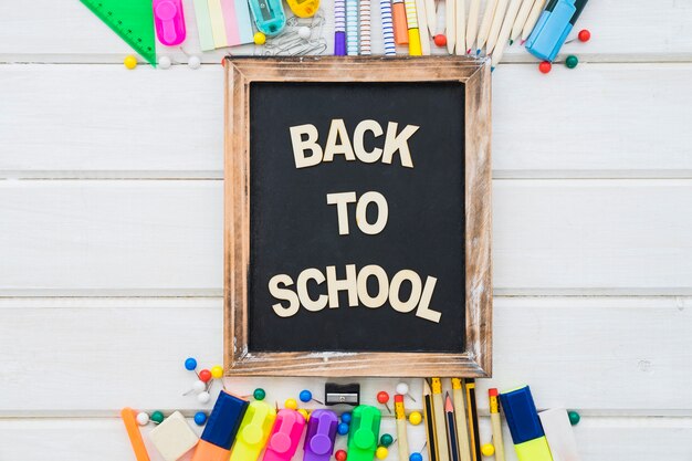 Back to school decoration with slate on wooden surface