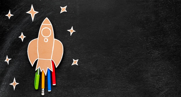 Back to school rocket with copy space and pencils