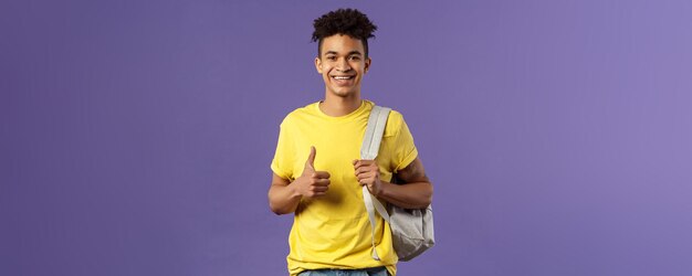 Back to school university concept portrait of cheerful handsome male student describe his summer vac