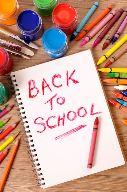 Back to school with notebook and crayons