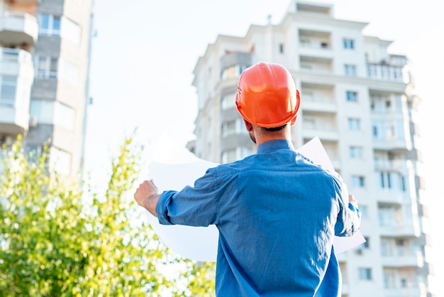 Free photo back view of architect reading schematic