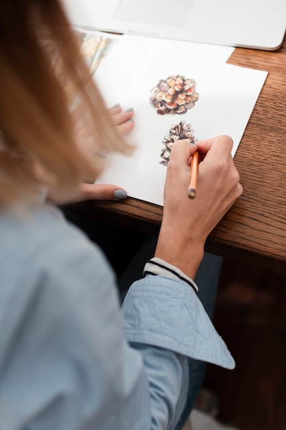 Back view of artist drawing flowers