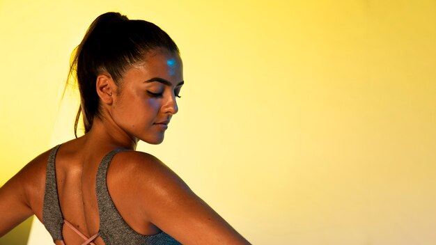 Back view of athlete with yellow background