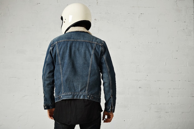 Free photo back view of athletic biker wearing club denim shearling jacket and helmet, isolated on white