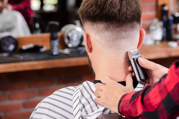 Back view barber trimming hair 