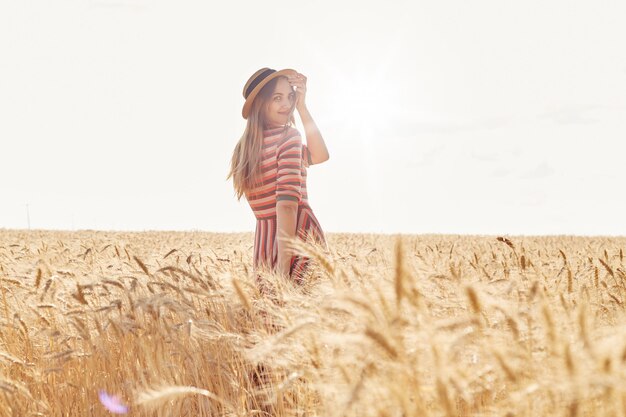 Back view of beautiful young woman in stylish striped dress