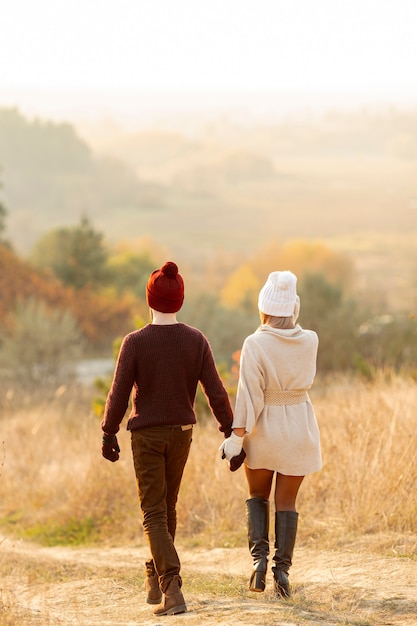 Free photo back view best friends holding hands