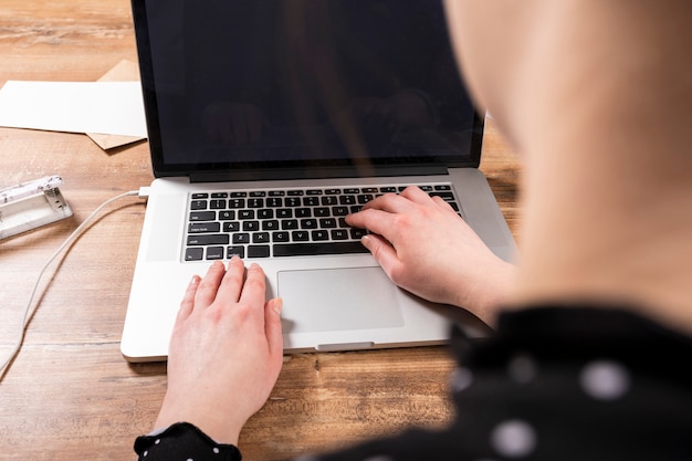 Back view business woman working on laptop