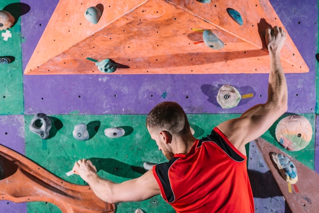 Back view climber on wall