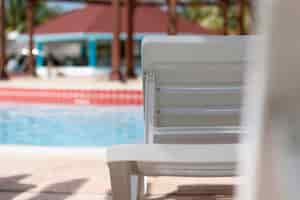 Free photo back view close up of beach chair at the pool