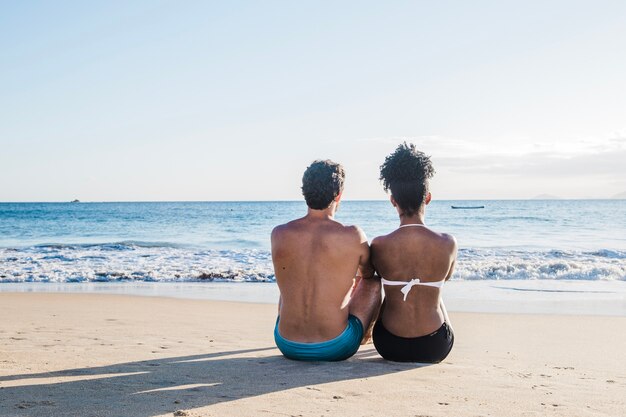 Back view of couple at the beach