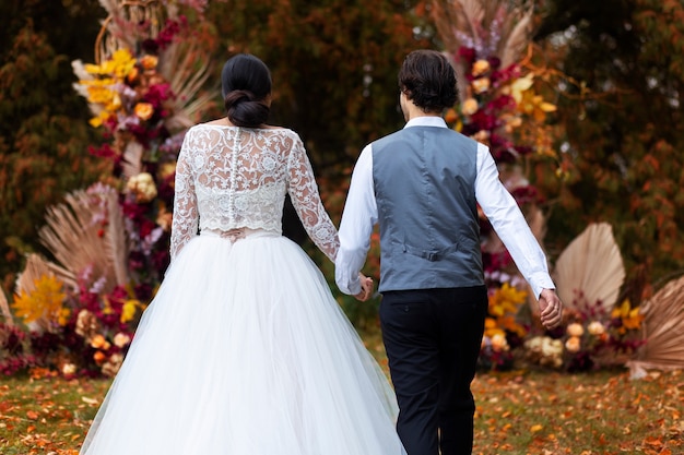 Free photo back view couple holding hands