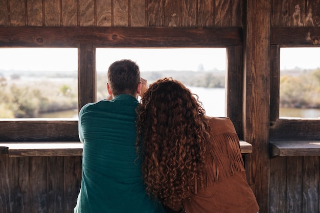 Back view couple inside a shelter