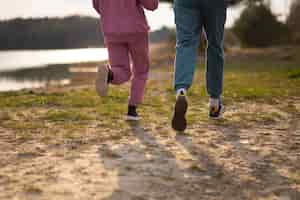 Free photo back view couple running outdoors