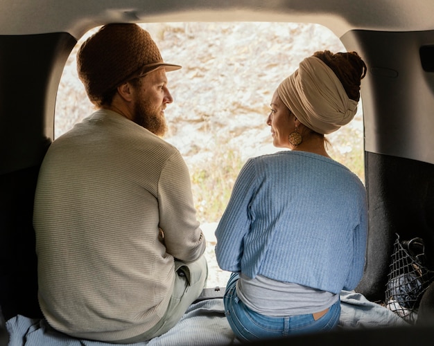 Free photo back view couple sitting in car