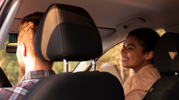 Free photo back view couple traveling by car