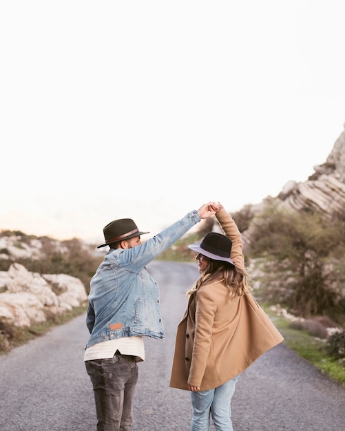 Back view couple walking on a road