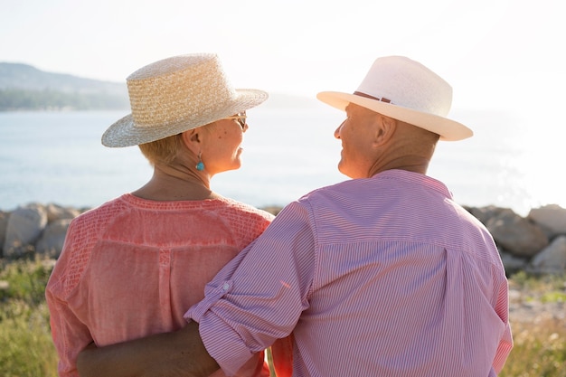 Free photo back view cute couple wearing hats