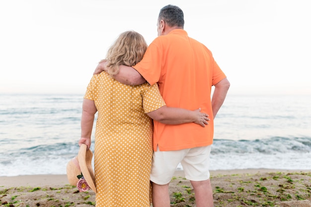 Back view of elder tourist couple